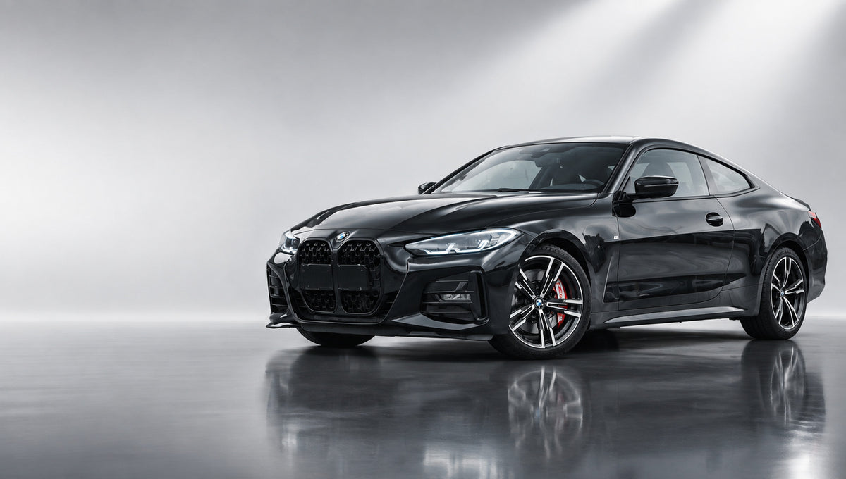 Matte black BMW 4 Series coupe with red TEI P60NS-Plus six-piston brake calipers in a light studio