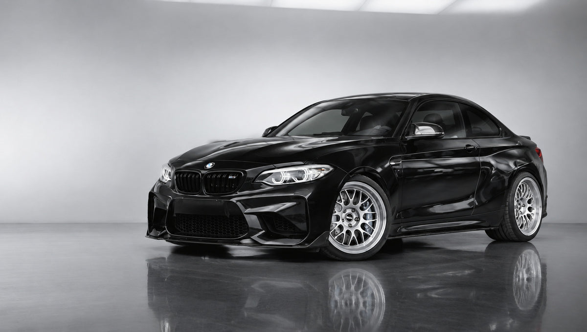 Black BMW M2 F87 track build with TEI GT60-MONO six-piston racing brake calipers in a light studio